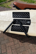 Close-up of the padded surf rack arms holding a surfboard