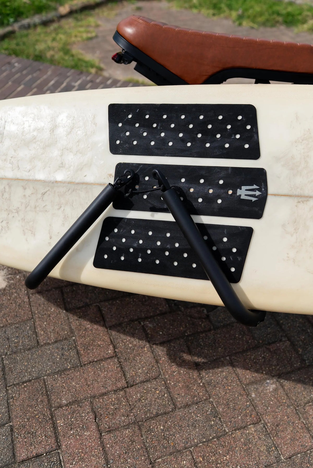 Close-up of the padded surf rack arms holding a surfboard